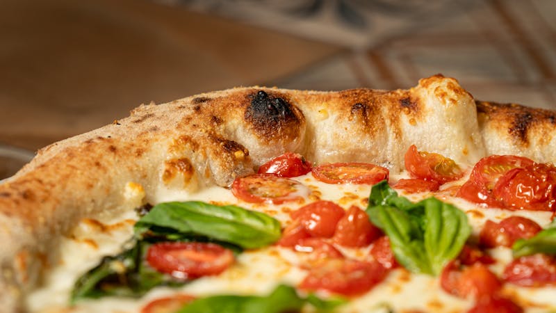 Bruschetta Classica — toasted bread with fresh tomatoes and basil at Pizzana